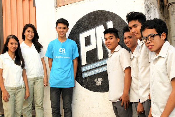 A group of PNP students in front of the PN logo at the center.