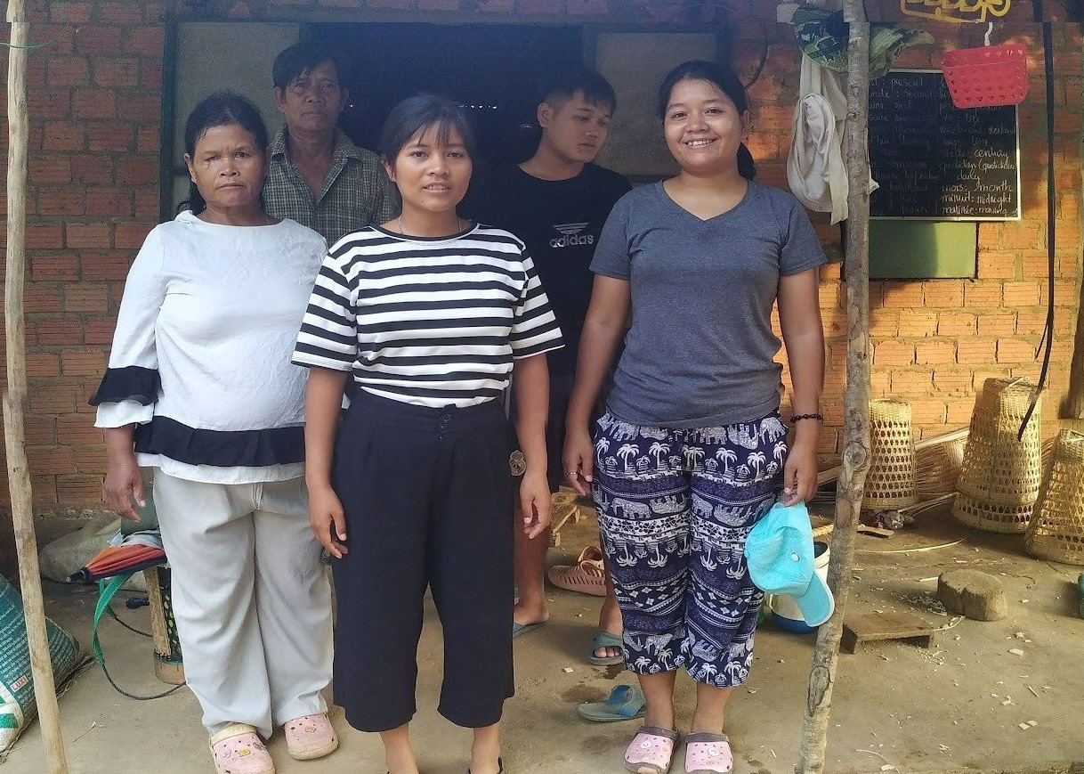 Bdao and her family in front of the old house